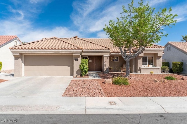 8812 Marble Dr, Las Vegas, NV 89134 - view of front of house featuring a garage, a tile roof, driveway, and stucco siding