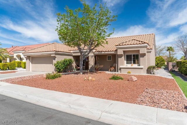 8812 Marble Dr, Las Vegas, NV 89134 - mediterranean / spanish house featuring a tile roof, stucco siding, an attached garage, and driveway