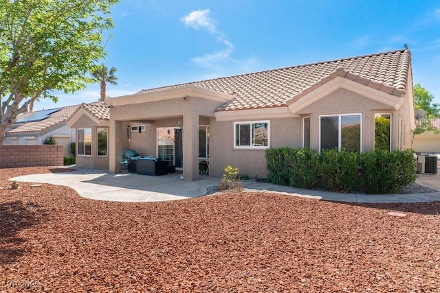 8812 Marble Dr, Las Vegas, NV 89134 - back of house with a tile roof, stucco siding, a patio area, and an outdoor hangout area