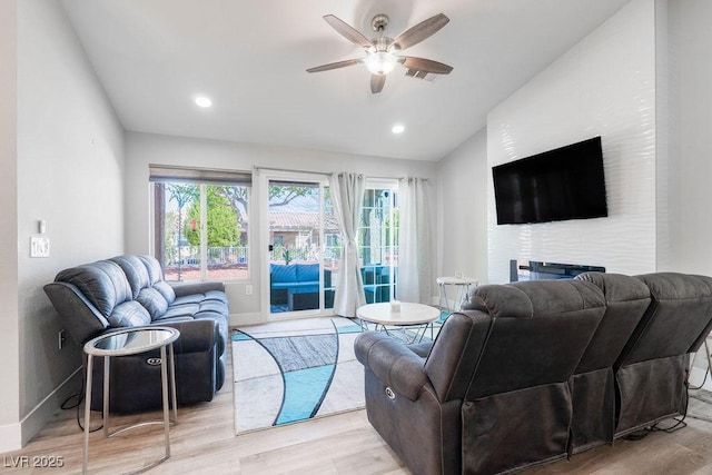 8812 Marble Dr, Las Vegas, NV 89134 - living area featuring ceiling fan, lofted ceiling, light wood-style flooring, a large fireplace, and recessed lighting