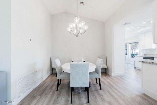 8812 Marble Dr, Las Vegas, NV 89134 - dining space featuring light wood-type flooring, a chandelier, and lofted ceiling