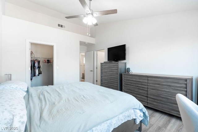 8812 Marble Dr, Las Vegas, NV 89134 - bedroom featuring a walk in closet, light wood-style flooring, and ceiling fan