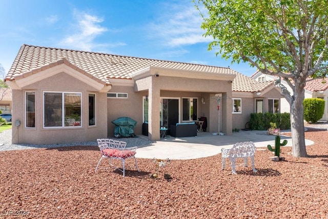 8812 Marble Dr, Las Vegas, NV 89134 - back of property featuring a tile roof, stucco siding, and a patio area