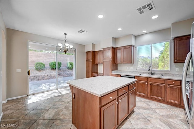 1013 Brinkman St, Las Vegas, NV 89138 - kitchen with healthy amount of natural light, a chandelier, light countertops, a center island, and recessed lighting