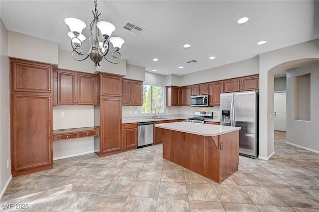 1013 Brinkman St, Las Vegas, NV 89138 - kitchen with appliances with stainless steel finishes, arched walkways, a chandelier, light countertops, and a center island