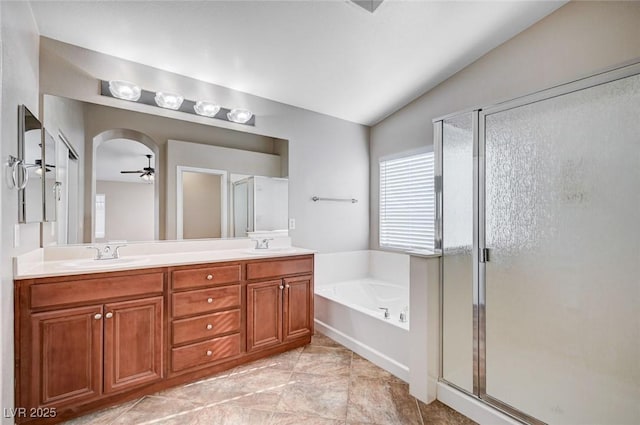 1013 Brinkman St, Las Vegas, NV 89138 - full bathroom featuring vaulted ceiling, a stall shower, a garden tub, double vanity, and a ceiling fan