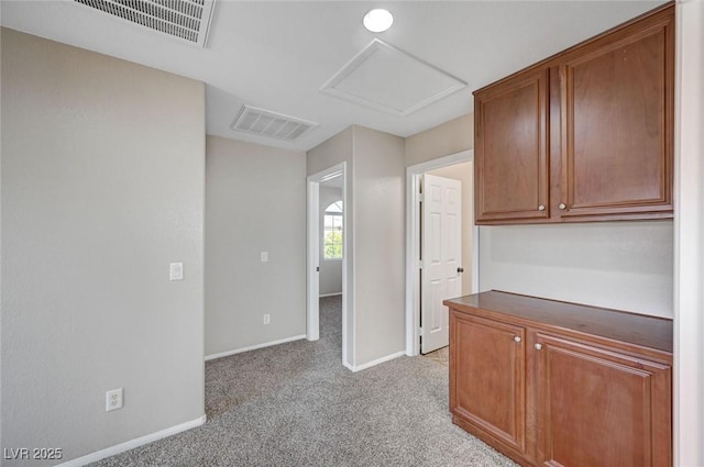 1013 Brinkman St, Las Vegas, NV 89138 - kitchen featuring light colored carpet, dark countertops, and brown cabinetry