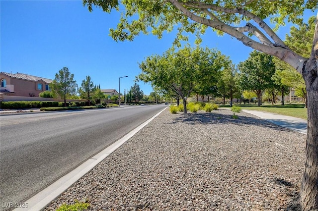 1013 Brinkman St, Las Vegas, NV 89138 - view of asphalt street featuring street lighting, sidewalks, and a residential view