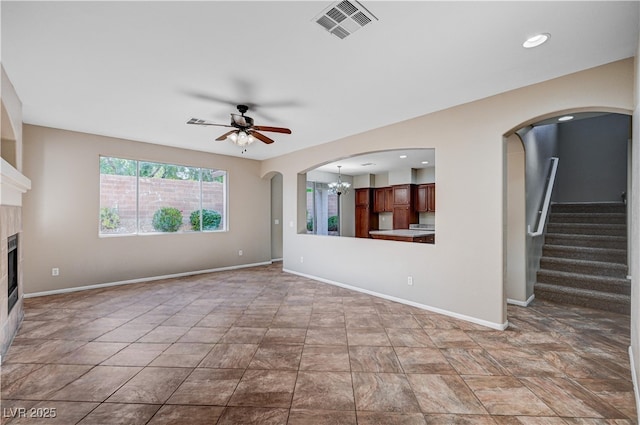 1013 Brinkman St, Las Vegas, NV 89138 - unfurnished living room with a ceiling fan, a tile fireplace, a chandelier, recessed lighting, and stairway
