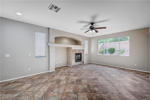 1013 Brinkman St, Las Vegas, NV 89138 - unfurnished living room featuring a ceiling fan, a tiled fireplace, and stone finish floors