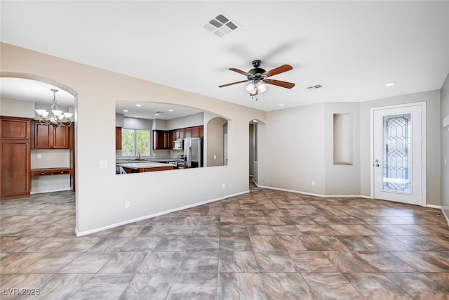 1013 Brinkman St, Las Vegas, NV 89138 - unfurnished living room with arched walkways, ceiling fan, a chandelier, and recessed lighting