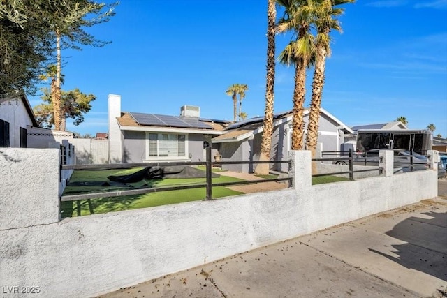 7026 Westpark Ct, Las Vegas, NV 89147 - view of front of house with a fenced front yard, roof mounted solar panels, stucco siding, and a chimney