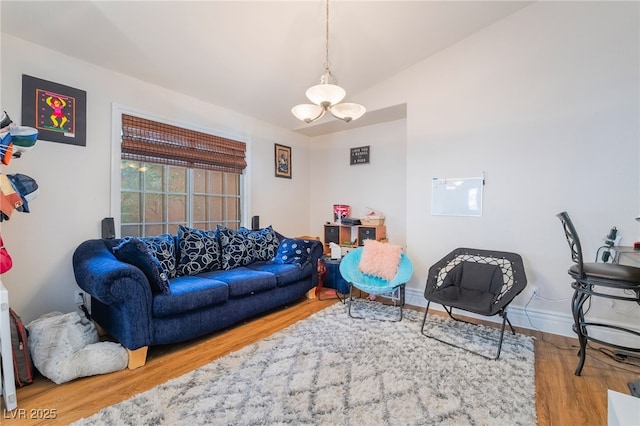 7517 Elk Meadows Ct, Las Vegas, NV 89131 - living room featuring wood finished floors, a chandelier, and vaulted ceiling