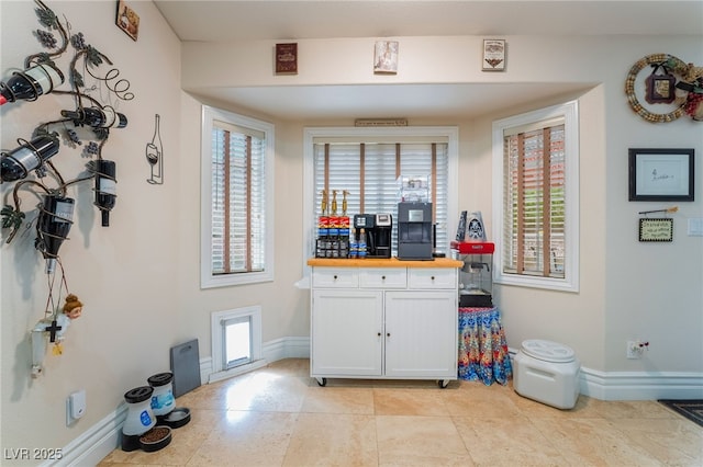 7517 Elk Meadows Ct, Las Vegas, NV 89131 - kitchen with white cabinetry, wood counters, and light tile patterned flooring