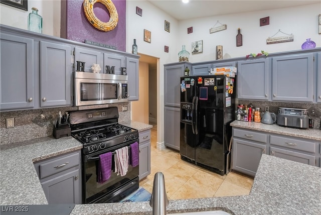 7517 Elk Meadows Ct, Las Vegas, NV 89131 - kitchen with black appliances, gray cabinetry, light countertops, and backsplash