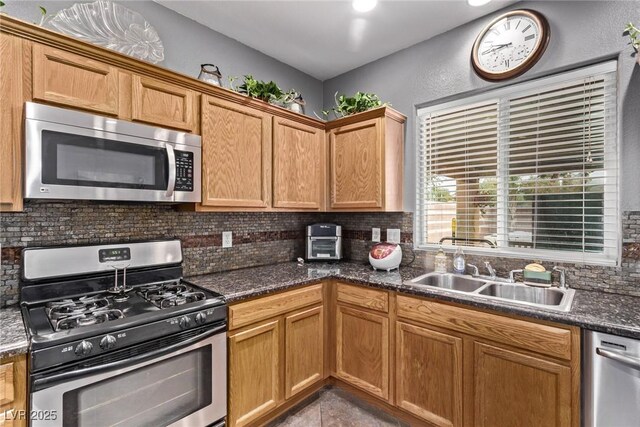 3005 Dotted Wren Ave, North Las Vegas, NV 89084 - kitchen with stainless steel appliances, tasteful backsplash, and dark stone counters