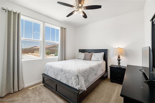 3568 E Malheur Ave, Pahrump, NV 89061 - bedroom with light colored carpet, a desk, and a ceiling fan