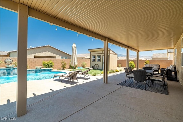 3568 E Malheur Ave, Pahrump, NV 89061 - fenced backyard with outdoor dining area, a patio area, and a storage unit