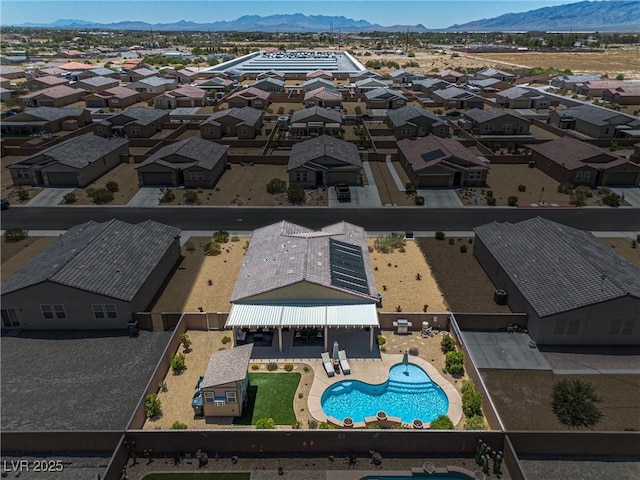 3568 E Malheur Ave, Pahrump, NV 89061 - aerial perspective of suburban area featuring a mountainous background and a pool area