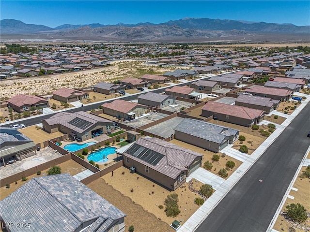 3568 E Malheur Ave, Pahrump, NV 89061 - aerial view of residential area featuring a mountain backdrop and a pool area