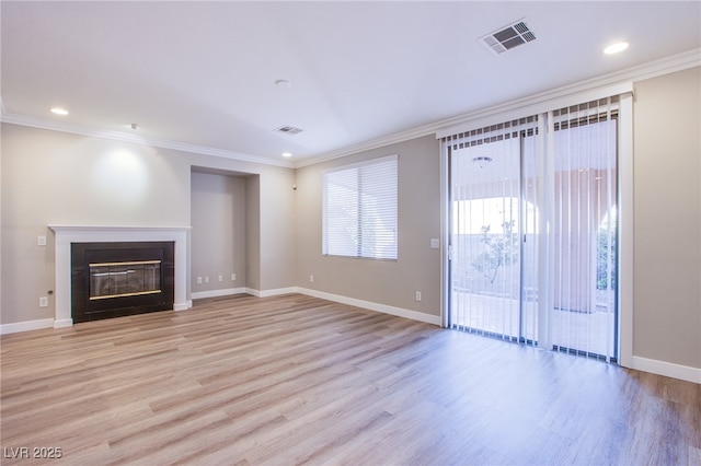 8026 Sunset Creek St, Las Vegas, NV 89113 - unfurnished living room with light wood-style floors, a glass covered fireplace, crown molding, and recessed lighting