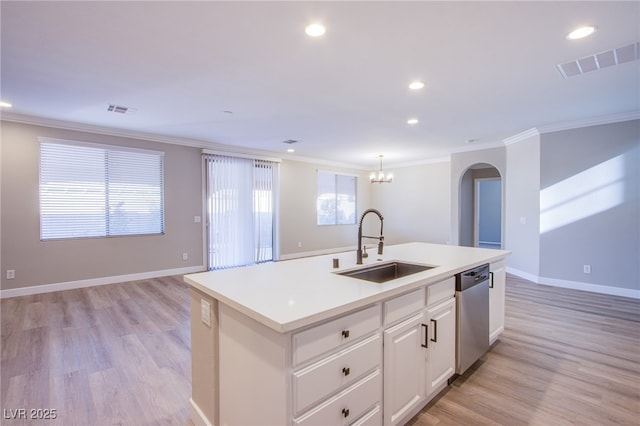 8026 Sunset Creek St, Las Vegas, NV 89113 - kitchen featuring stainless steel dishwasher, arched walkways, ornamental molding, a center island with sink, and light wood-style floors