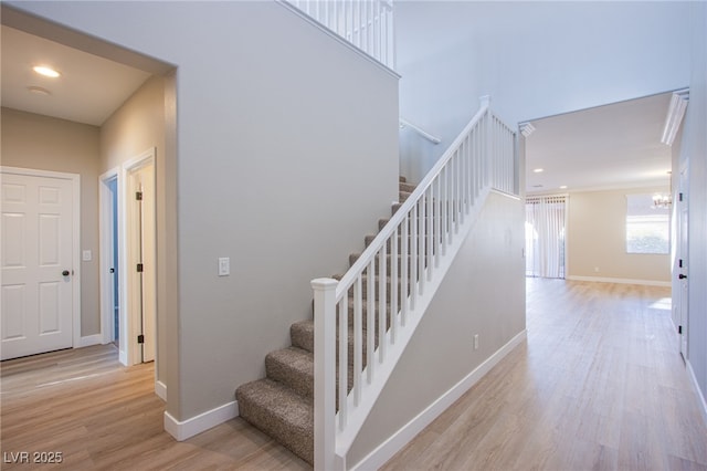 8026 Sunset Creek St, Las Vegas, NV 89113 - stairway with wood finished floors, a chandelier, and recessed lighting