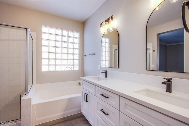 8026 Sunset Creek St, Las Vegas, NV 89113 - full bathroom featuring a garden tub, double vanity, tiled shower, and wood finished floors