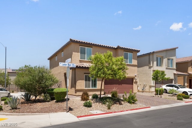 4498 Lantern Point Ave, North Las Vegas, NV 89084 - view of front of property with an attached garage, stucco siding, a tile roof, and decorative driveway