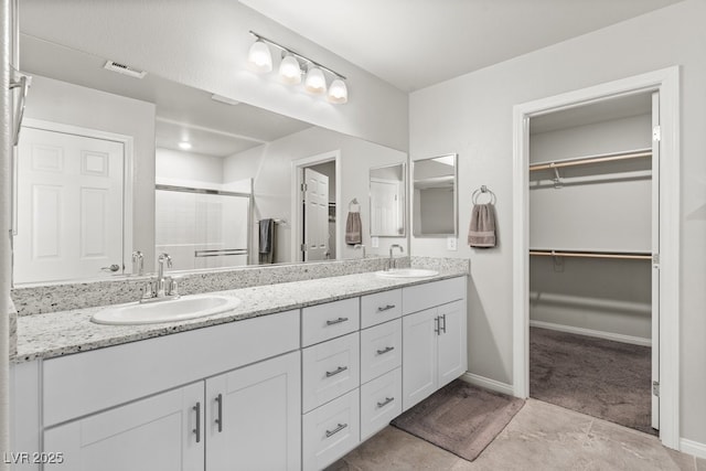 4498 Lantern Point Ave, North Las Vegas, NV 89084 - full bathroom featuring double vanity, a stall shower, and a spacious closet