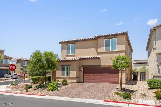 4498 Lantern Point Ave, North Las Vegas, NV 89084 - mediterranean / spanish house with a tile roof, an attached garage, stucco siding, and decorative driveway