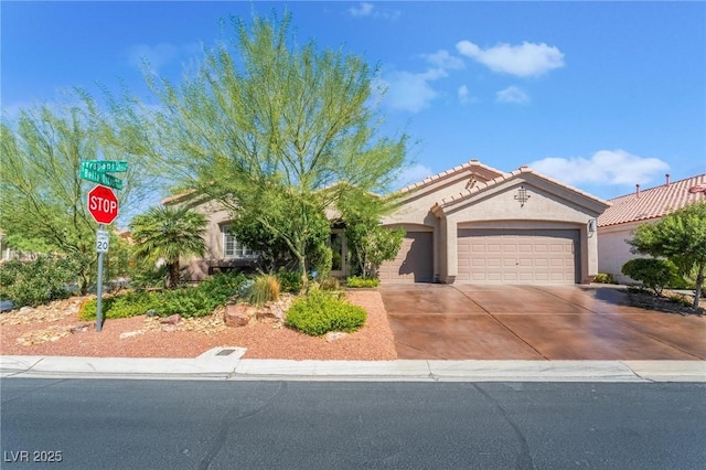4014 Trapani Pl, Las Vegas, NV 89141 - view of front of property with a garage, stucco siding, concrete driveway, and a tile roof