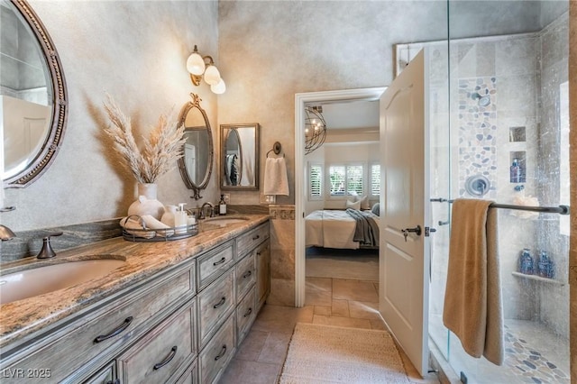 4014 Trapani Pl, Las Vegas, NV 89141 - ensuite bathroom with double vanity, a stall shower, and stone tile floors