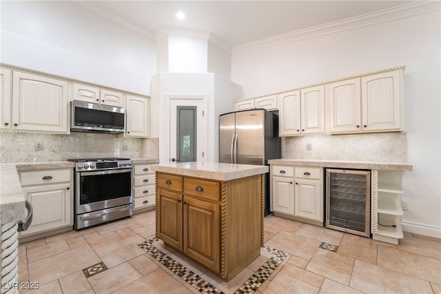 4014 Trapani Pl, Las Vegas, NV 89141 - kitchen with stainless steel appliances, wine cooler, light countertops, tasteful backsplash, and ornamental molding