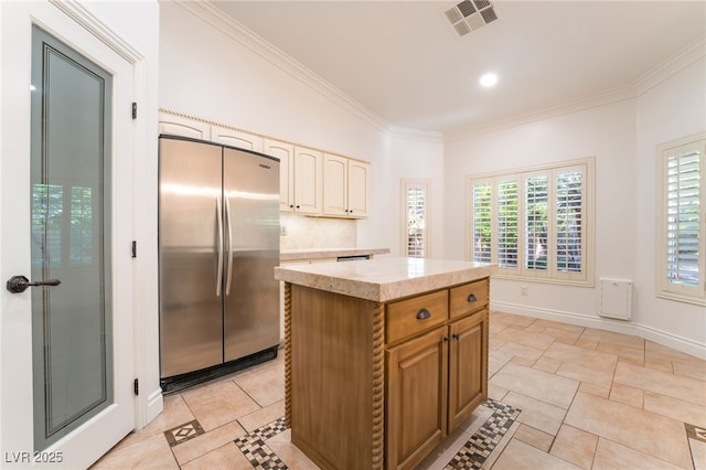 4014 Trapani Pl, Las Vegas, NV 89141 - kitchen with freestanding refrigerator, light countertops, crown molding, a kitchen island, and backsplash