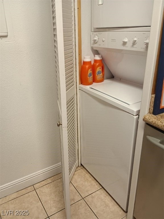 1515 E Reno Ave Unit D202, Las Vegas, NV 89119 - laundry room with stacked washer / dryer and light tile patterned floors