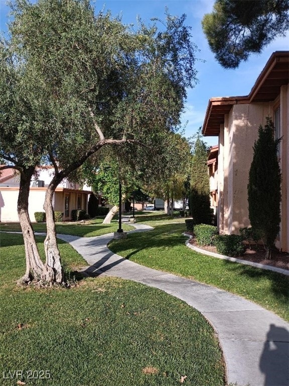 1515 E Reno Ave Unit D202, Las Vegas, NV 89119 - surrounding community with a lawn