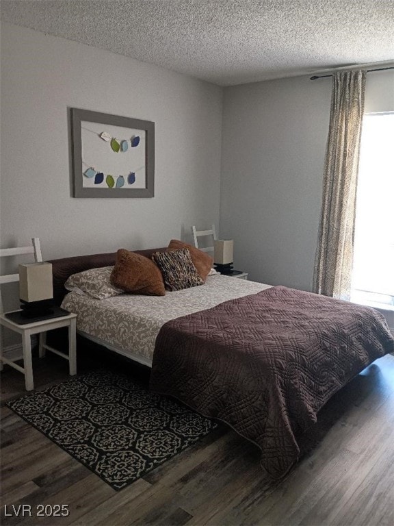 1515 E Reno Ave Unit D202, Las Vegas, NV 89119 - bedroom with wood finished floors and a textured ceiling