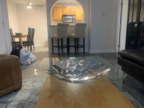 1515 E Reno Ave Unit D202, Las Vegas, NV 89119 - living room featuring a ceiling fan and arched walkways