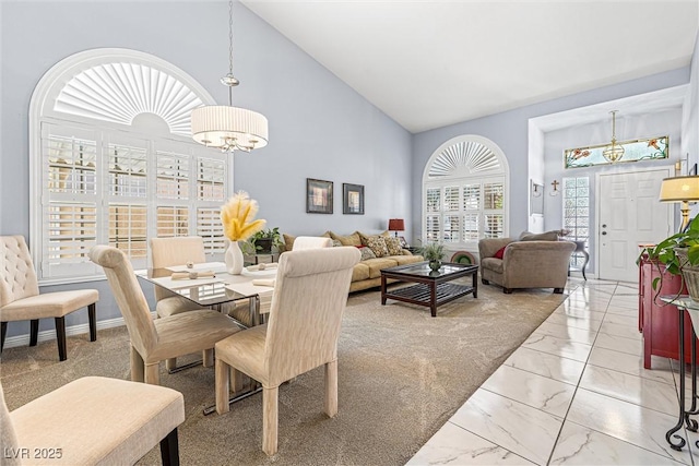 2042 Maple Springs St, Henderson, NV 89002 - dining room featuring light marble finish flooring, high vaulted ceiling, and a chandelier
