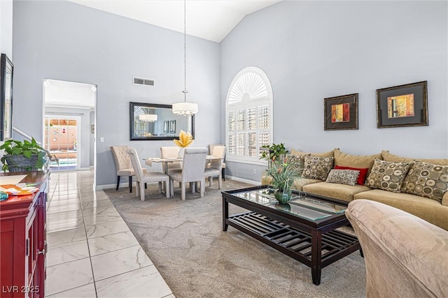 2042 Maple Springs St, Henderson, NV 89002 - living area with marble finish floors, a chandelier, and high vaulted ceiling