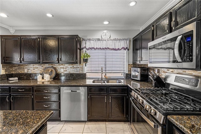 2042 Maple Springs St, Henderson, NV 89002 - kitchen featuring appliances with stainless steel finishes, ornamental molding, tasteful backsplash, dark stone countertops, and light marble finish flooring