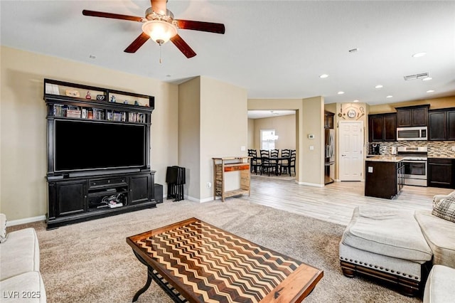 6897 Linda Creek Ct, Las Vegas, NV 89178 - living area with light carpet, a ceiling fan, and recessed lighting