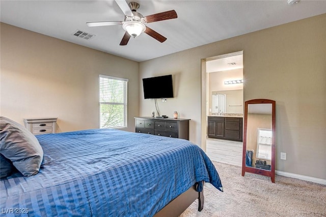 6897 Linda Creek Ct, Las Vegas, NV 89178 - bedroom with light colored carpet, connected bathroom, and ceiling fan
