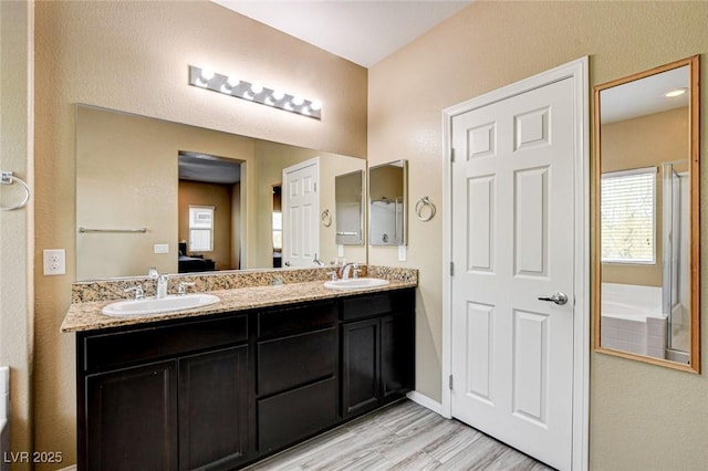 6897 Linda Creek Ct, Las Vegas, NV 89178 - ensuite bathroom with double vanity and wood finished floors