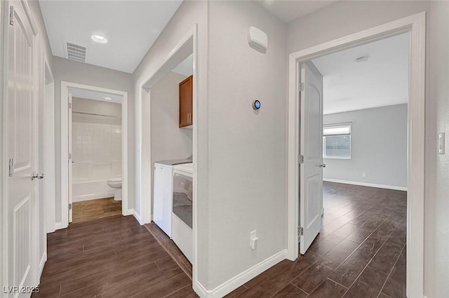 3908 Total Eclipse St, Las Vegas, NV 89129 - hallway featuring independent washer and dryer and dark wood finished floors