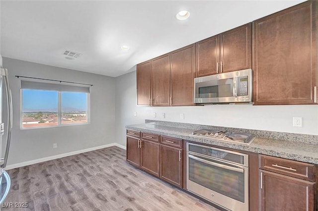3908 Total Eclipse St, Las Vegas, NV 89129 - kitchen with stainless steel appliances, light wood-style floors, and recessed lighting