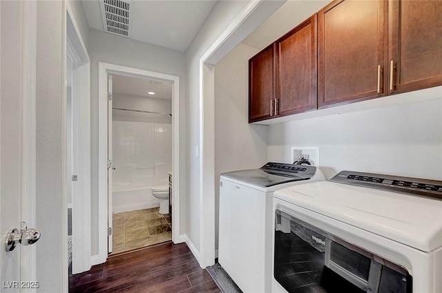 3908 Total Eclipse St, Las Vegas, NV 89129 - laundry area with cabinet space, independent washer and dryer, and dark wood-style flooring