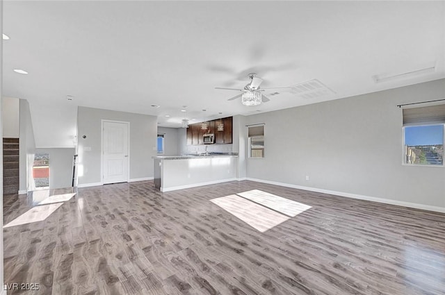 3908 Total Eclipse St, Las Vegas, NV 89129 - unfurnished living room featuring ceiling fan, wood finished floors, recessed lighting, and stairs