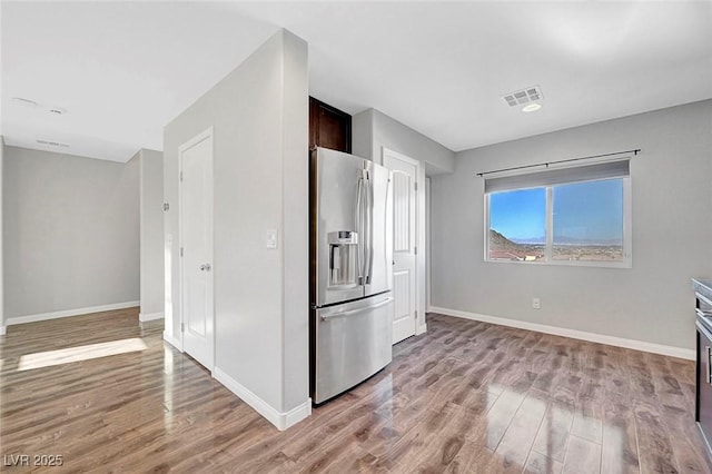 3908 Total Eclipse St, Las Vegas, NV 89129 - kitchen featuring stainless steel refrigerator with ice dispenser, light wood-type flooring, and dark brown cabinets